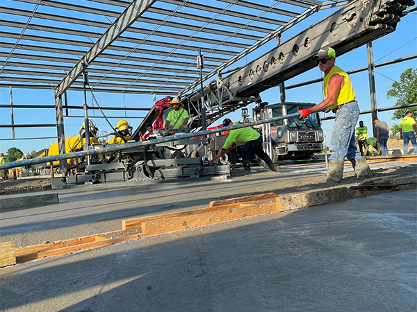 Close up of a construction site where concrete is being finished by workers. 