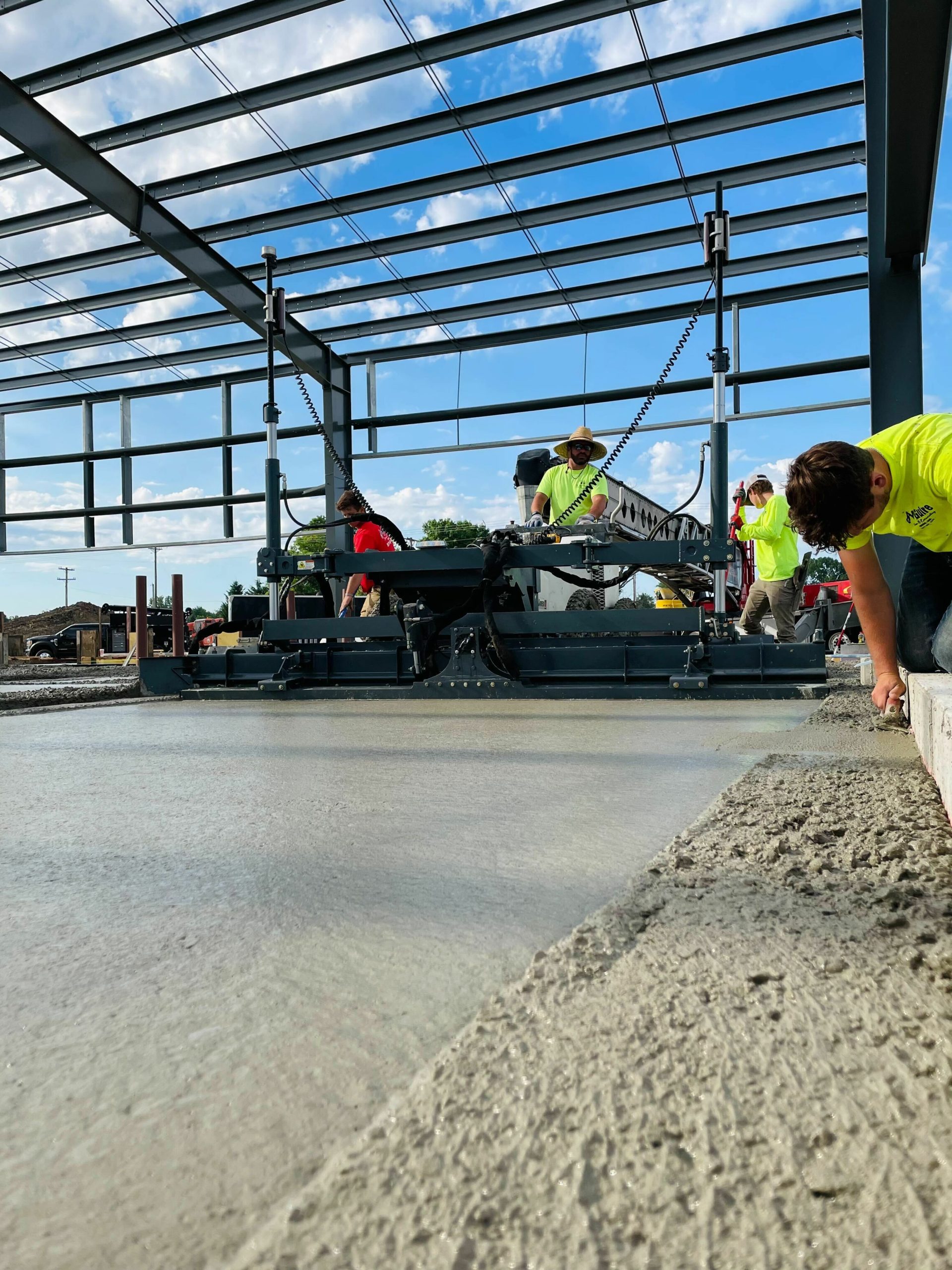 Construction site of concrete being smoothed with a power laser screed.