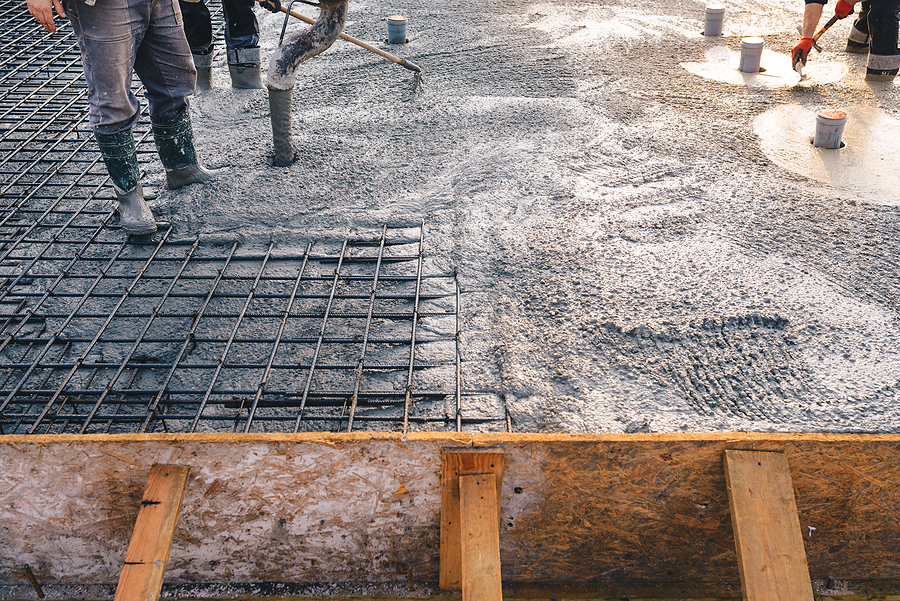 Closeup of concrete pouring during a commercial construction project.