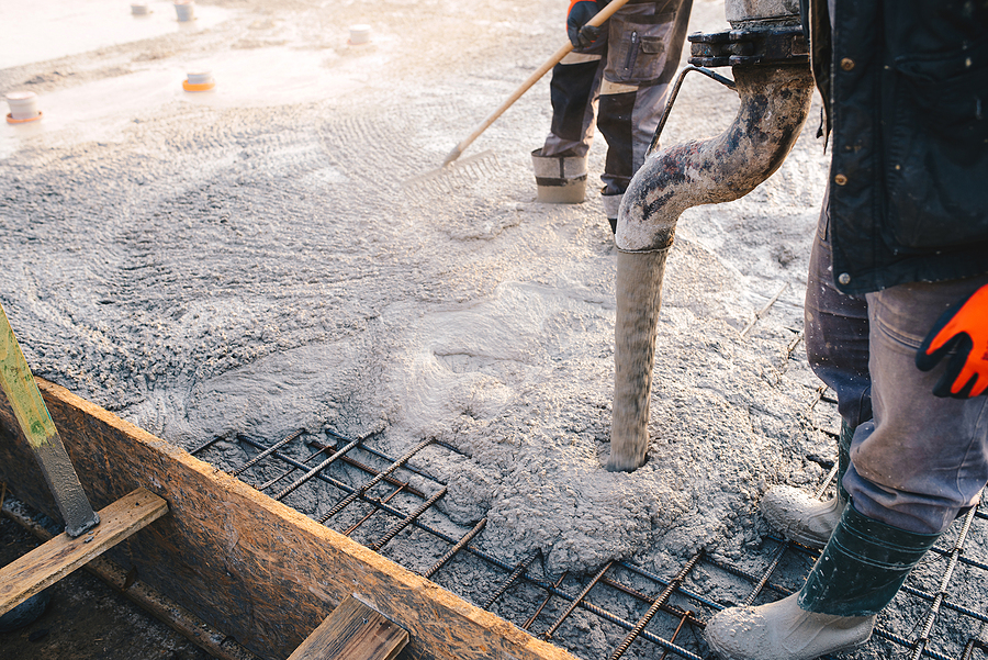 Closeup of a concrete pour at a construction site.