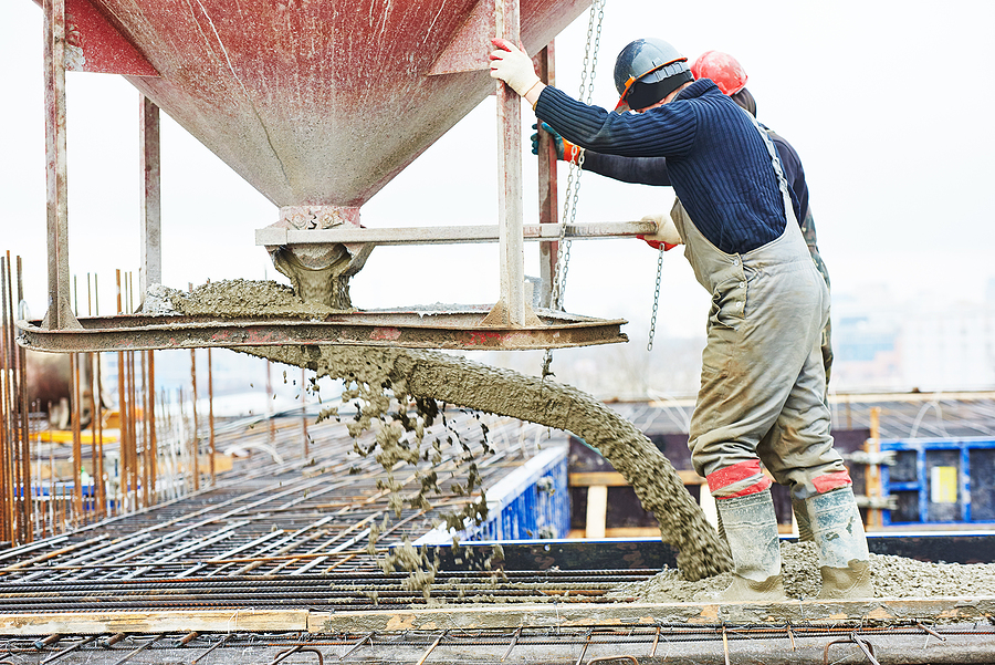 Construction workers during a concrete pour at a large construction site. 