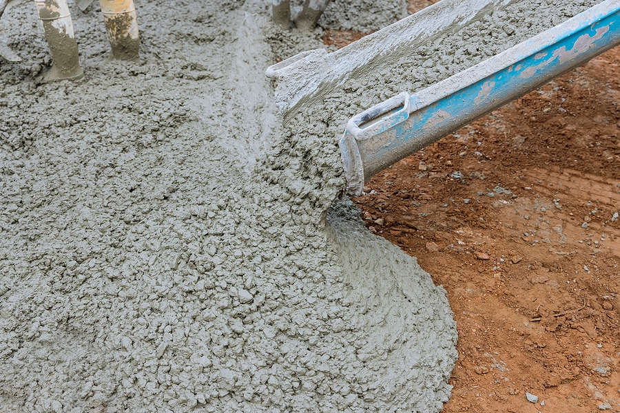 Closeup of a concrete pour at a large construction site. 